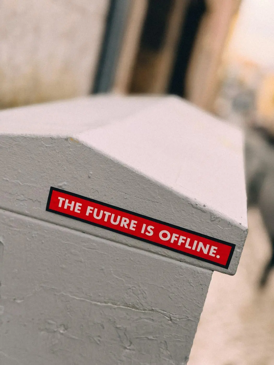 Auto-generated description: A red sticker on a gray surface reads THE FUTURE IS OFFLINE.