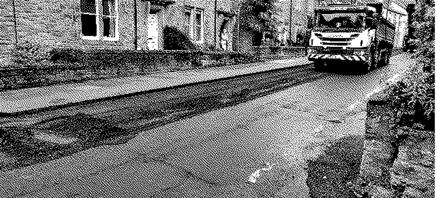 Road being resurfaced with lorry