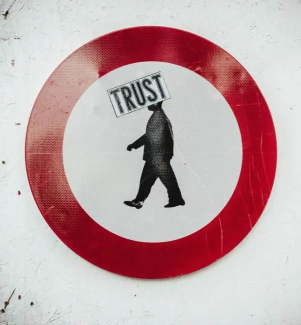 Auto-generated description: A circular sign with a red border depicts a silhouette of a walking person and the word TRUST above them.