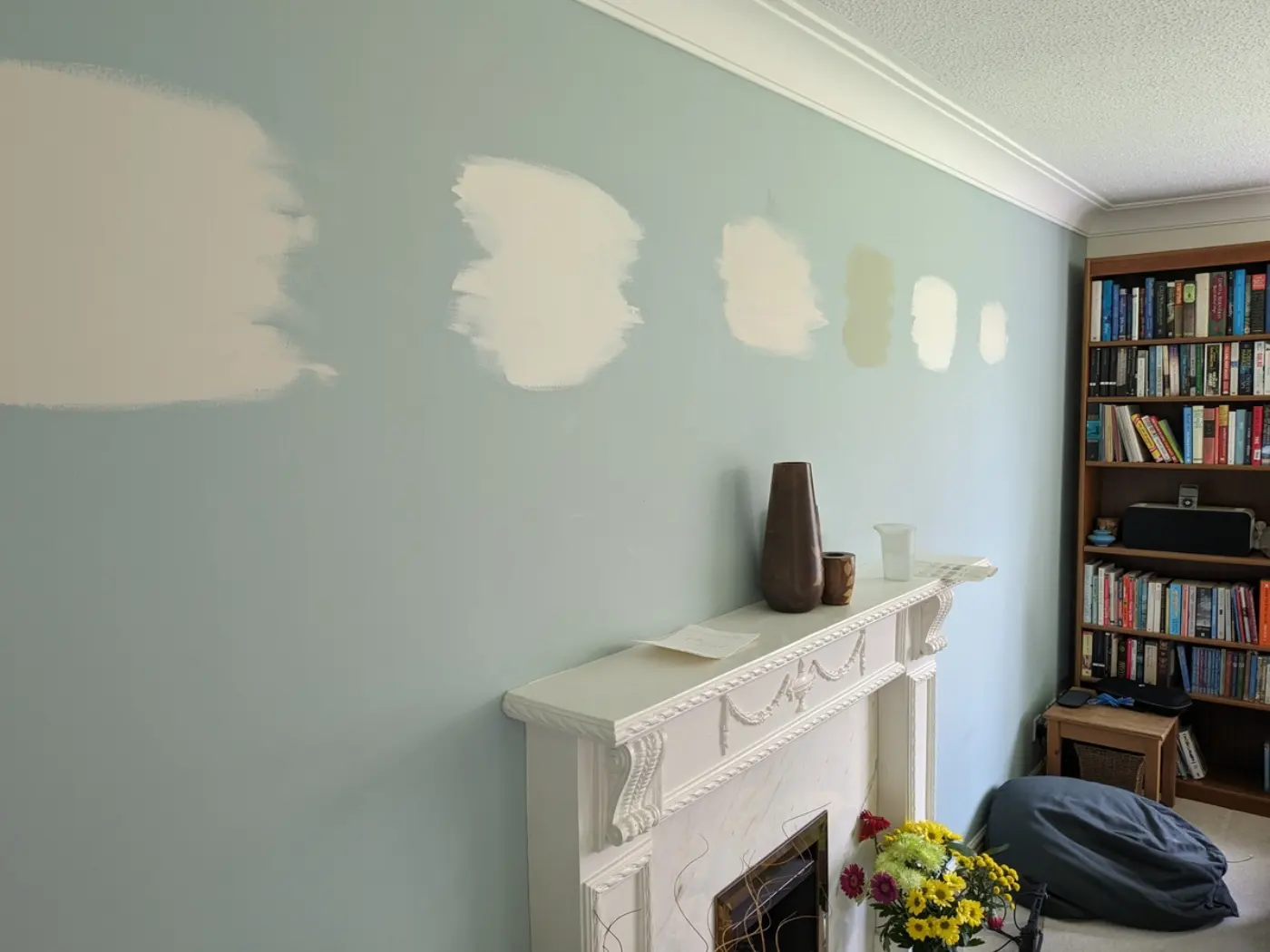 Paint from tester pots helping us choose which shade of cream/magnolia to replace the colour on a feature wall in the lounge of our new house, soon after moving.