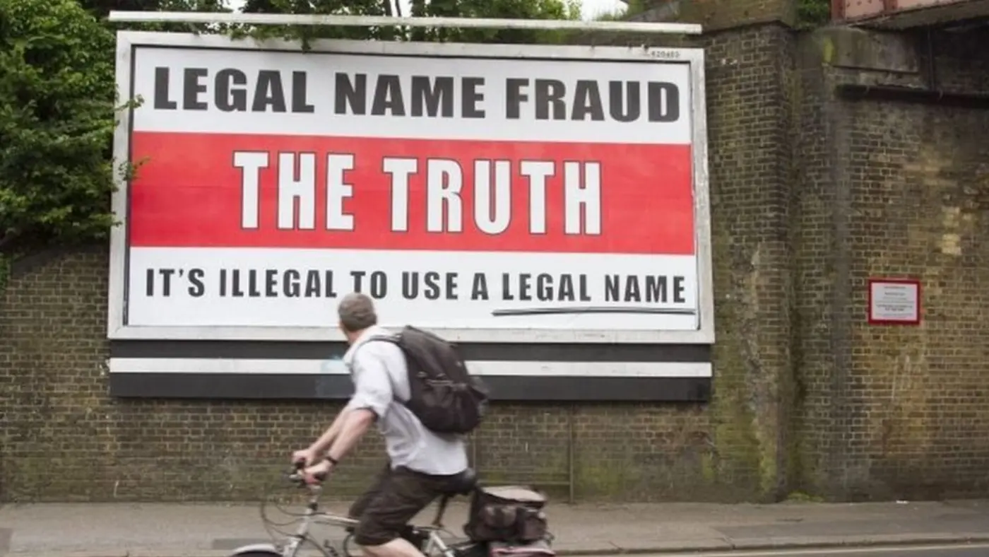 Billboard advert: "Legal name fraud. The Truth. It's illegal to use a legal name." Photo via the BBC.